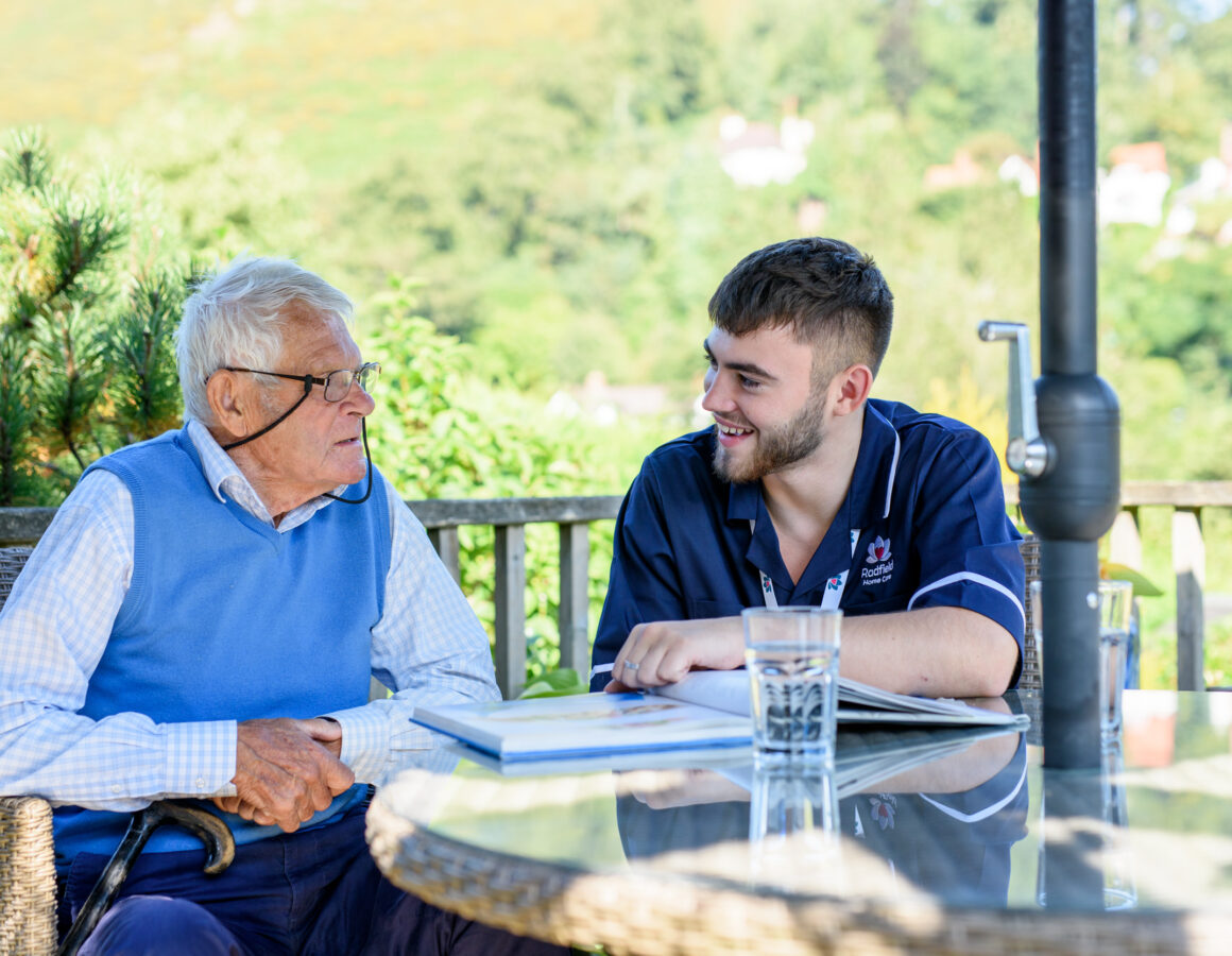 Male carer with client outside