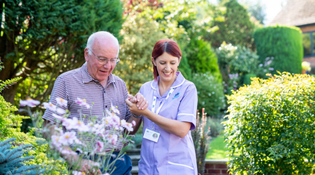care professional with client in the garden