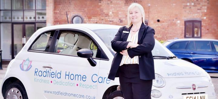 dawn phillips first franchise partner standing by a radfield home care car