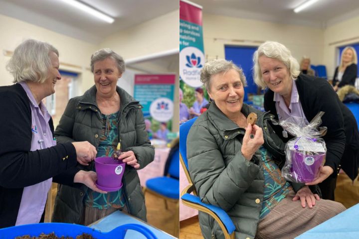 client and carer laughing and looking at flowers