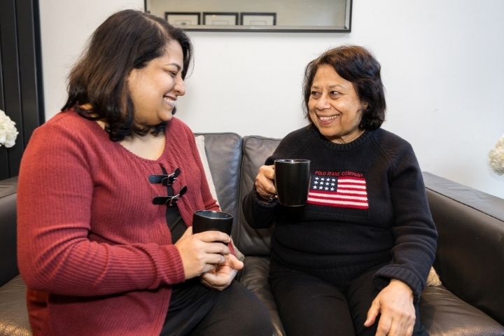 female care professional and female client having a coffee together