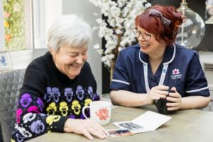Client and Care Professional looking at photos.