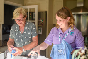 Alternatives to care homes. Client with Care professional in a Live in care setting
