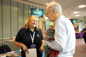 Radfield employee talking with an older person at the See Hear Remember Information Day Shrewsbury