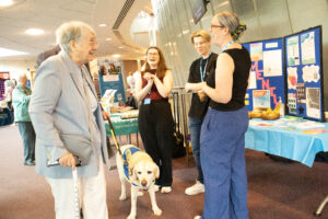 Attendees laughing with exhibitors at the Shrewsbury See Hear Remember Information & Dementia Day