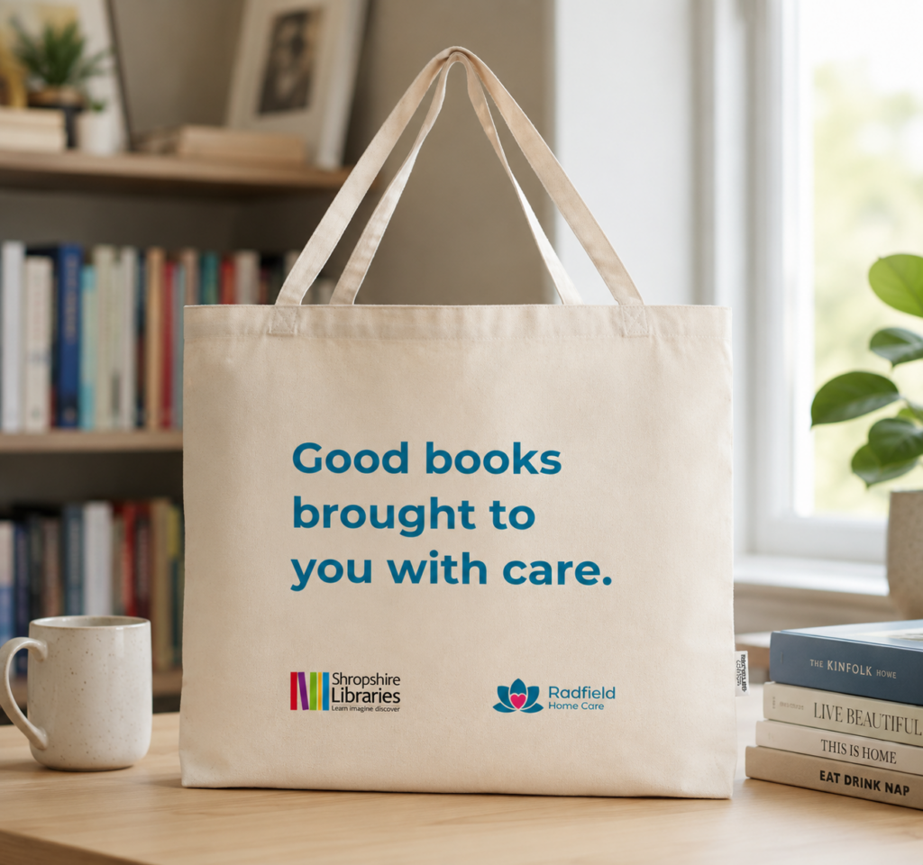 An image showing what the tote bags look like with the shared branding of Shropshire Libraries and Radfield Home Care. The image was edited with support from AI software.