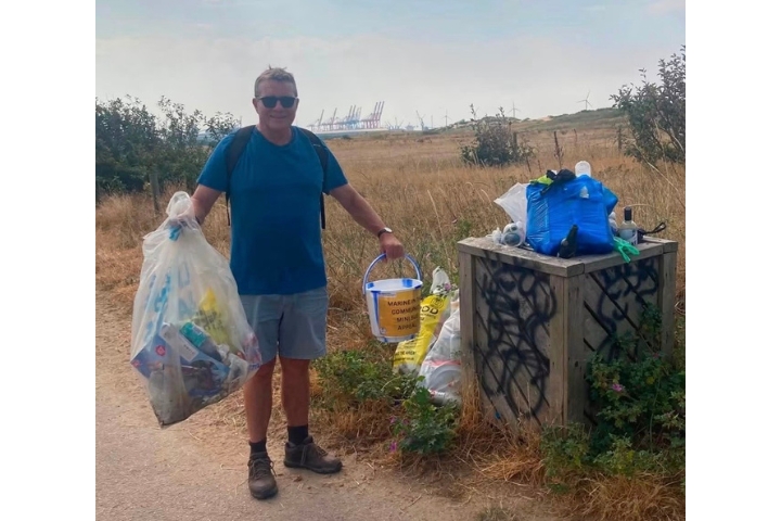 Dave Bellis getting involved in litter picking during the community charity walk in Crosby.