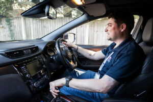 Image of a Care Professional sat in his car