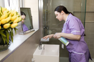 Care Professional cleaning the house of a client