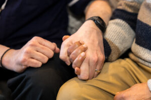 Client and their relative holding hands