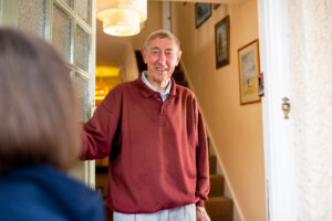 An image of a parent opening a door - Topic, can my parent live alone
