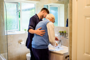 A Care Professional helping a client at home