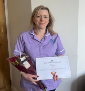 Anne receiving employee of the month and answering can you switch from childcare to adult social care
