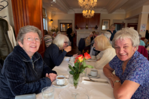 Picture of clients at the dinner, helping them tackle loneliness in older people in Liverpool by attending friendship groups for older people in Waterloo